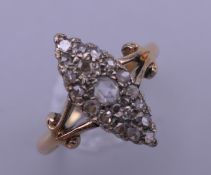An 18 ct gold and diamond navette ring. Ring size N/O. 4.1 grammes total weight.