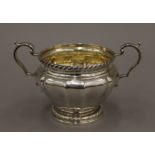 A twin handled silver sugar bowl. 16.5 cm wide. 11.5 troy ounces.