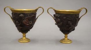 A pair of 19th century Elkington Grand Tour style gilded and patinated bronze urns. 15 cm high.