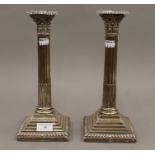 A pair of silver Corinthian column candlesticks. Each 29.5 cm high.