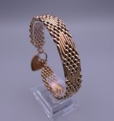 A 9 ct gold bracelet with padlock fastener. Approximately 18.5 cm long. 27 grammes.