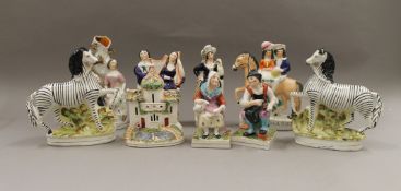 A collection of Staffordshire figurines, including a pair of Zebra.