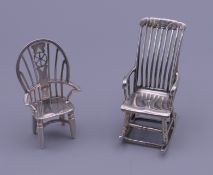 Two miniature silver chairs. The largest 5 cm high. 30.9 grammes.