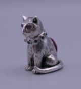 A silver pin cushion formed as a cat. 2.75 cm high.