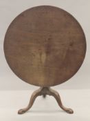 A Georgian mahogany tilt top tripod table. 91 cm diameter.