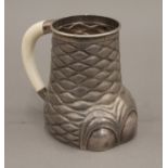 A late 19th/early 20th century Indian silver tankard formed as an elephant's foot with ivory handle.