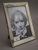 A silver photograph frame, hallmarked Birmingham 1927. 16.5 x 21.5 cm.