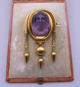 A boxed Victorian unmarked gold cameo brooch. 7 cm high. 24.3 grammes total weight.
