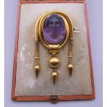 A boxed Victorian unmarked gold cameo brooch. 7 cm high. 24.3 grammes total weight.