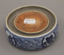 A Chinese blue and white porcelain inkstone. 11 cm diameter.