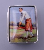 A silver pill box depicting a golfer. 3 cm high.