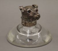 A Victorian silver mounted glass inkwell, the lid formed as a terrier's head. 11.5 cm high.