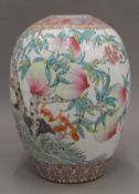 A Chinese porcelain vase decorated with peaches and bats. 33 cm high.