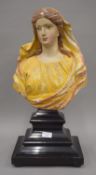 An antique polychrome painted carved wooden bust of a lady,