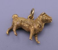 A 9 ct gold boarder terrier/pug pendant. 1.8 cm wide. 1 gram.