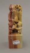 A Chinese figural soapstone seal. 15 cm high.