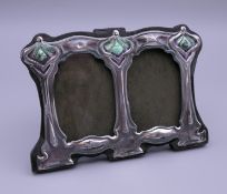 An Art Nouveau style silver double photograph frame. 11 cm wide.