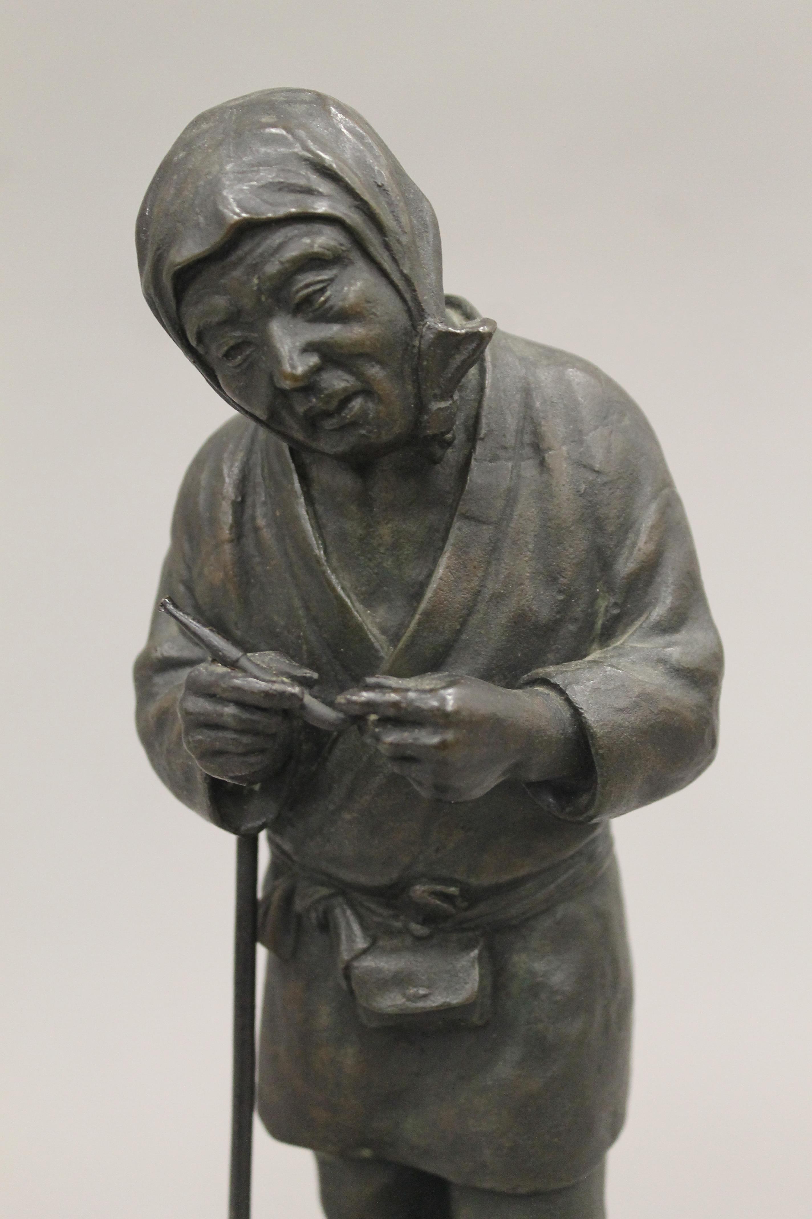 A Japanese Meiji period bronze model of a farmer. 30 cm high. - Image 4 of 4
