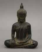 A patinated bronze model of Buddha. 14 cm high.