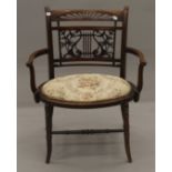 An Edwardian inlaid walnut open armchair. 61 cm wide.