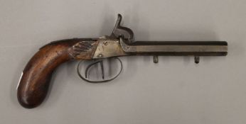 A 19th century double barrel percussion pistol. 23 cm long.