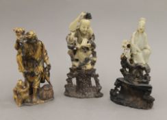 Three Oriental carved soapstone figures. The largest 18 cm high.