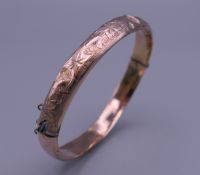 A 9 ct gold bangle form bracelet. 6.5 cm wide. 6.8 grammes.