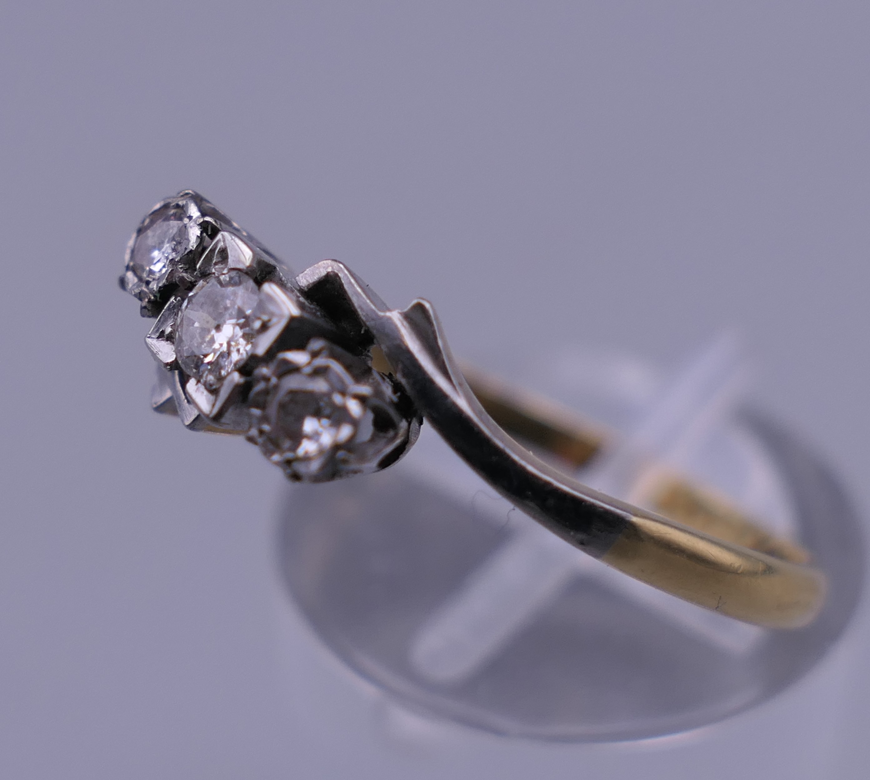 An 18 ct gold and platinum three stone diamond ring. Ring size R/S. 2.6 grammes total weight. - Image 3 of 6