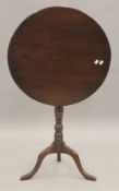 A 20th century mahogany tilt top tripod table. 59 cm diameter.