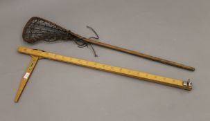 A vintage height measure and a Lacrosse racket.