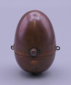 A Victorian copper egg shaped sovereign holder. 4.5 cm high.