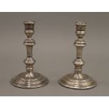 A pair of silver candlesticks. 16 cm high.