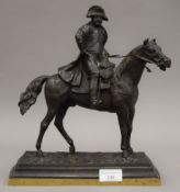 A 19th century patinated bronze model of Napoleon. 31.5 cm high.