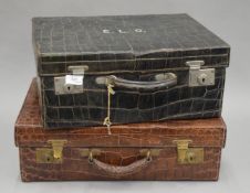 Two crocodile skin suitcases. The largest 51 cm wide.
