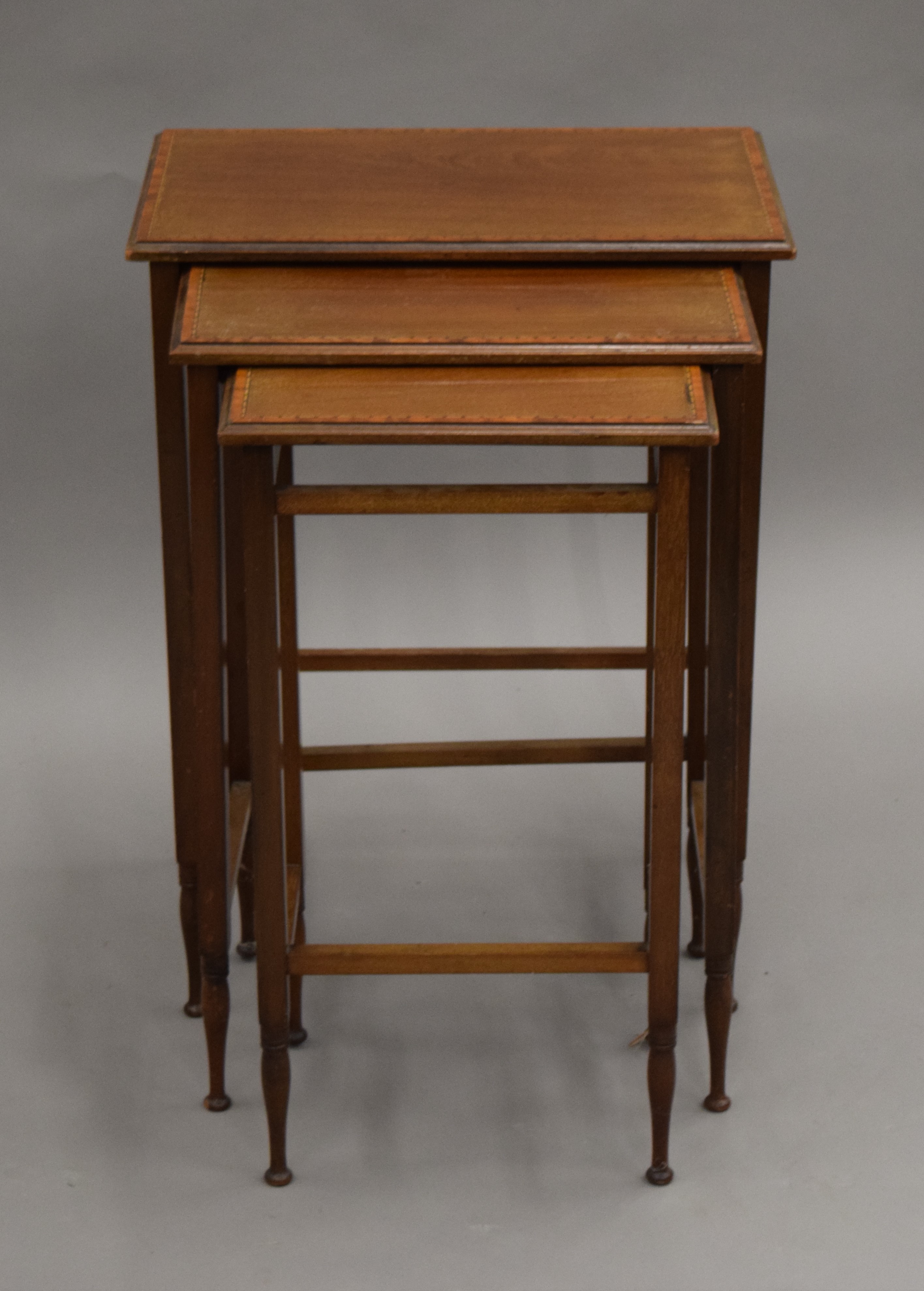 An Edwardian mahogany nest of three tables. 49 cm wide.