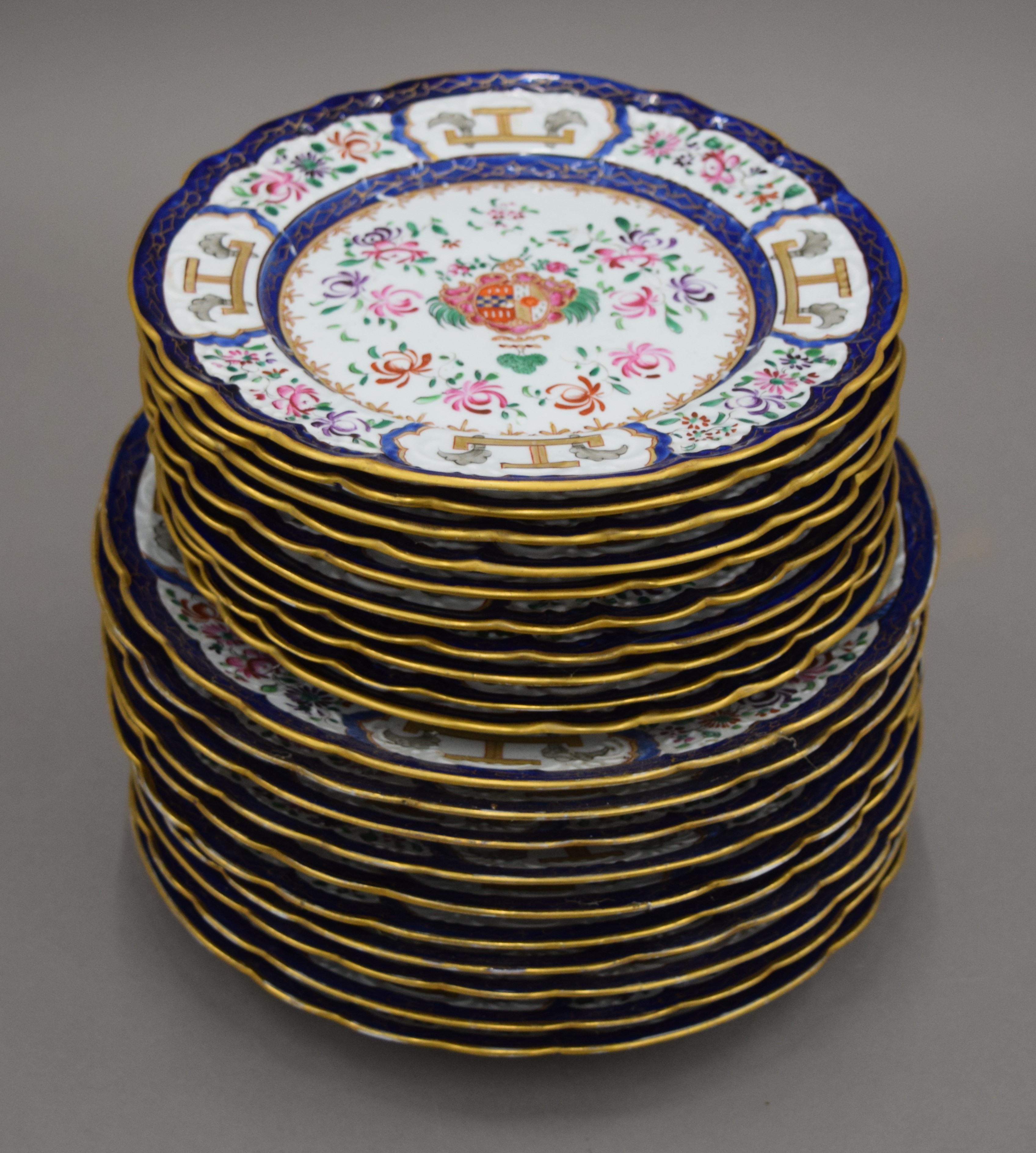 Twenty 19th century Armorially decorated porcelain plates. The larger each 24 cm diameter.