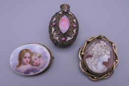 A Victorian 9 ct gold mounted painted porcelain brooch, a Victorian cameo brooch and a scent bottle.