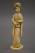 A 19th century Japanese carved ivory okimono formed as a geisha. 17 cm high.