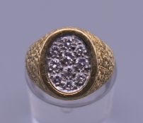 A Kutchinsky 18 ct gold and diamond ring. Ring size F/G. 13.3 grammes total weight.