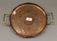 An Art Nouveau copper and brass tray. 33 cm wide.