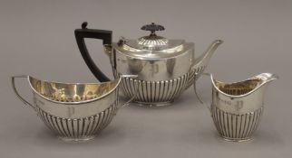 A silver three-piece tea set. The teapot 11 cm high. 12.8 troy ounces total weight.
