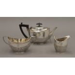 A silver three-piece tea set. The teapot 11 cm high. 12.8 troy ounces total weight.