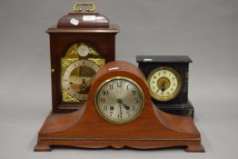 A Victorian slate mantle clock and two others. The former 20 cm high.