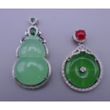 Two jade dress pendants. The largest 5.5 cm high.