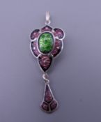 An Art Nouveau style sterling silver pendant. 2 cm wide.