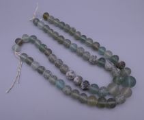 A glass trade bead necklace, restrung (shipwreck find). Approximately 100 cm long.