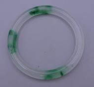 A green and white jade bangle. 7.5 cm exterior diameter.