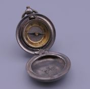 A compass fob in the shape of a sovereign holder. 3.25 cm diameter.