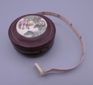 A bone and wooden tape measure. 5.5 cm diameter.