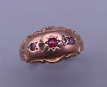 A 9 ct gold, diamond and ruby gypsy set ring. Ring size O/P. 2 grammes total weight.